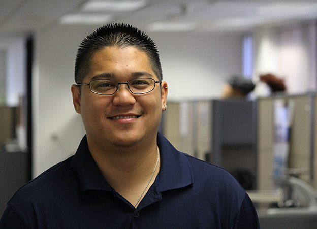 Jenly Chen, smiling, standing in an office setting