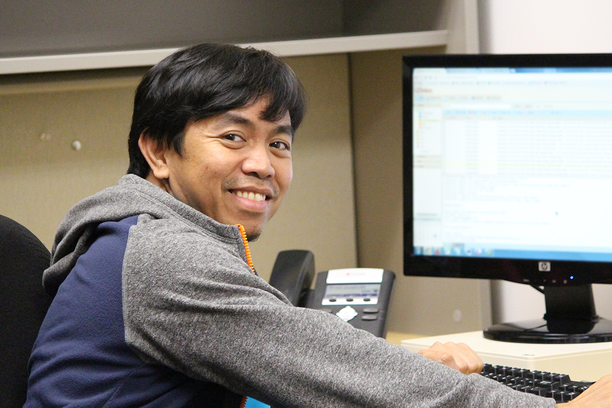 Bobby Bundac smiling and working at a computer